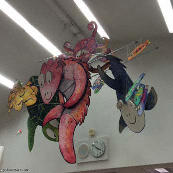 A colorful, glittery, hanging mobile of colorful sea creatures fishing in the school library