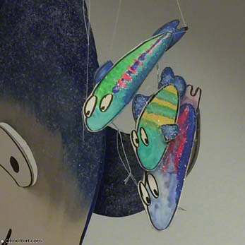 a group of colorful foam core Small Fry watch bigger sea creatures fish in a tidepool